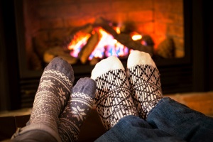 Feet warming by fireplace