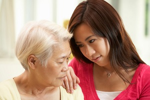 Unhappy Chinese Mother Being Comforted By Adult Daughter