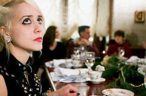 young woman looking anxious at holiday dinner