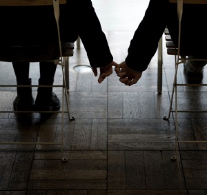 man holding a woman's little finger