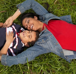 mother and her son lying on the grass