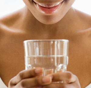 Woman holding glass of water