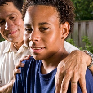 man with arm around shoulder of son