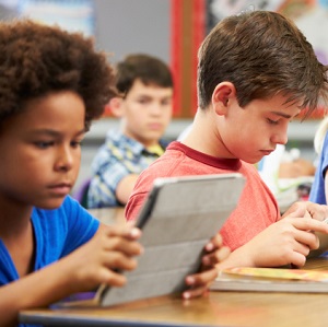 Pupils In Class Using Digital Tablet