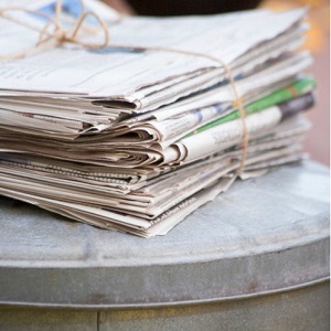 newspapers sitting on garbage can