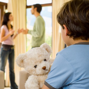 Boy with teddy bear and parents fighting