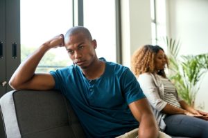 Couple in disagreement sitting on a couch