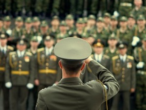 Officer saluting a military brigade