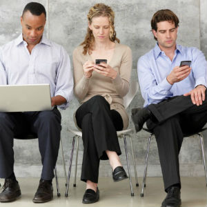 three people on electronic devices