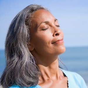 mature woman smiling with her eyes closed
