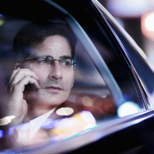 man talking on phone while driving