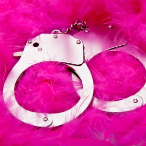 handcuffs on pink feathers