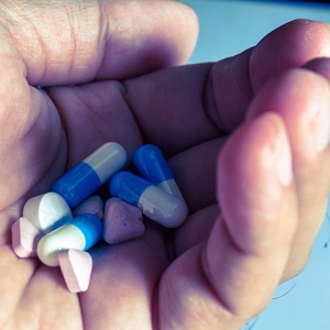 Medicine pill and capsules in hand