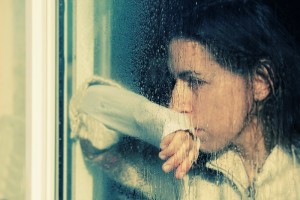 Sad woman looking out window