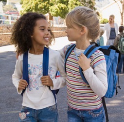 Two young friends talk intimately after school