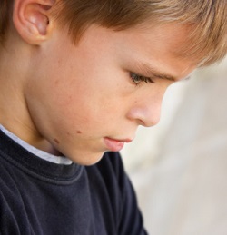 Boy hangs his head in despair