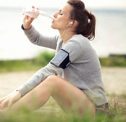 Woman breaks for water while exercising