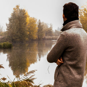 man standing by a lake