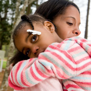 mother hugging her daughter