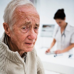 An unhappy elderly man visits a medical facility