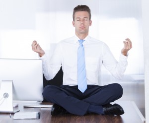 Businessman Meditating on Desk