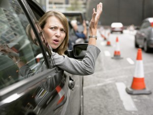 Anoyed Woman Looking Out Her Car Window Gesturing