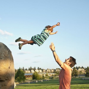 child jumping into arms of dad