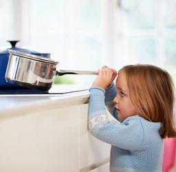 Child reaches for stovetop pan