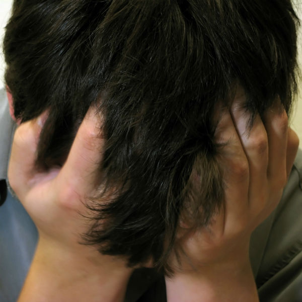 man with his head in his hands