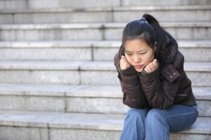 Sad woman sit on stairs