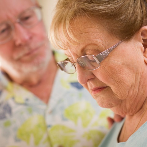 Man consoles woman looking down