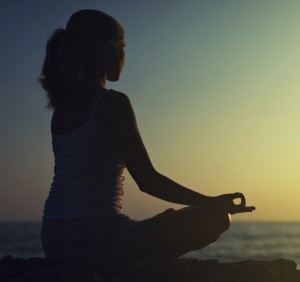 yoga outdoors. silhouette of a woman sitting in lotus position