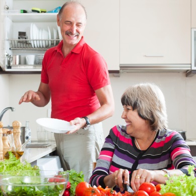A mature couple working in the kitchen together