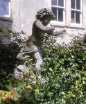A Cupid statue in a garden