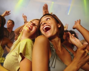 Happy extroverted women dancing at the nightclub. 