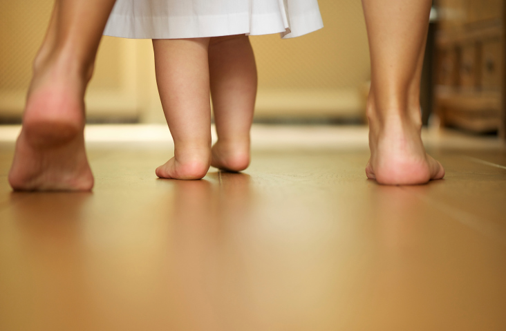 Feet of mother and baby walking