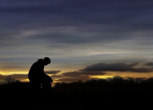 Sad man sitting in sunset