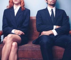 Man and woman waiting on a sofa