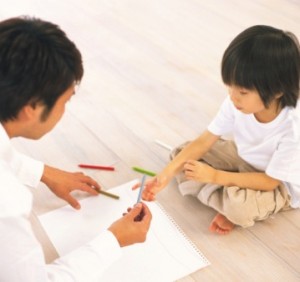 Father and child painting a picture
