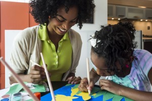 Mother and daughter (8-9) doing arts and crafts