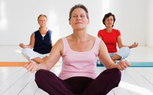 Women meditating with eyes closed