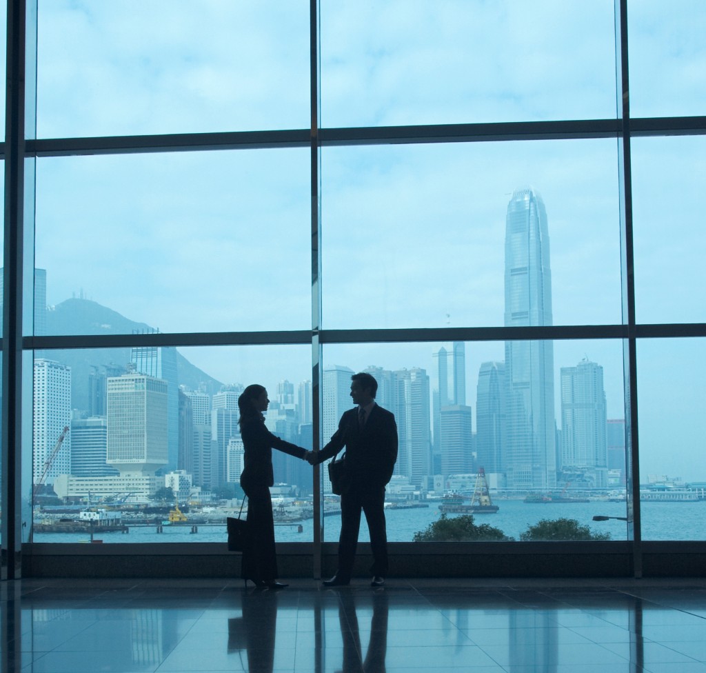 Businesspeople Shaking Hands in Office Lobby