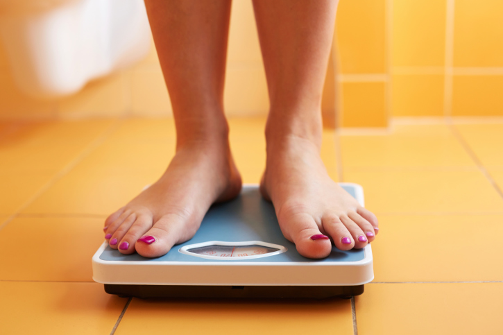 A woman's feet on a bathroom scale