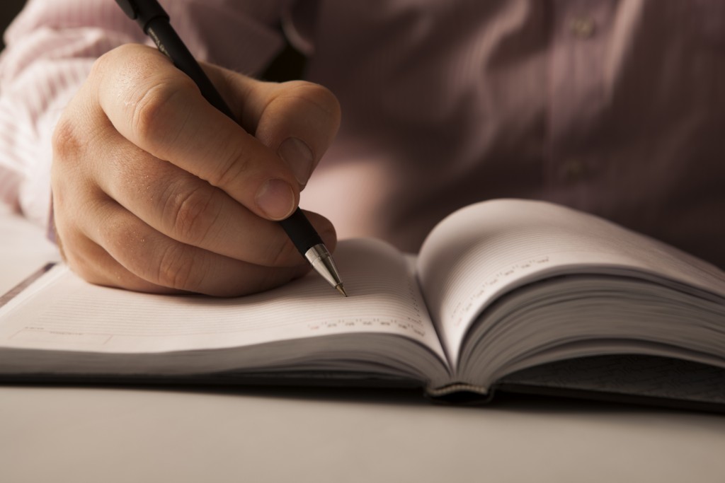 Man writing in book