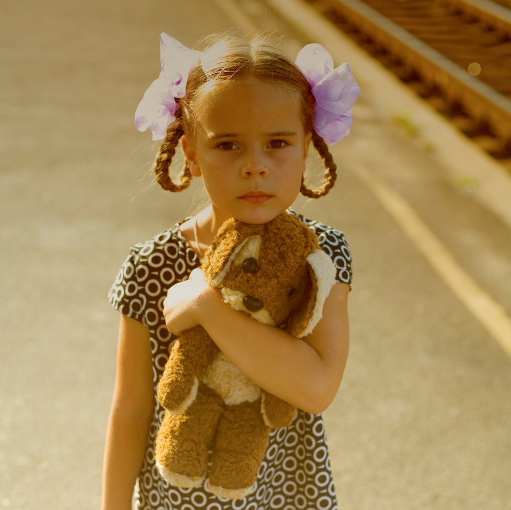 Retro portrait of a little girl at railway platform