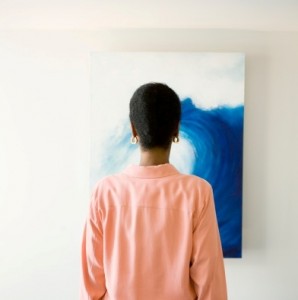 woman looking at painting