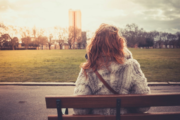 woman sitting alone on bench
