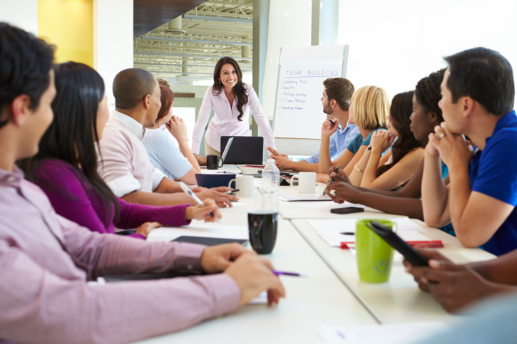 A woman speaks during work meeting