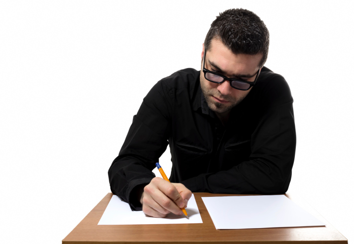 Man at desk completes written test