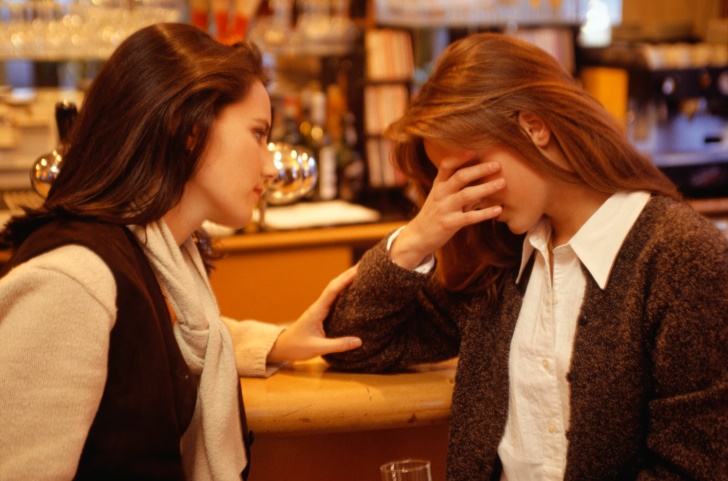 woman comforting another woman